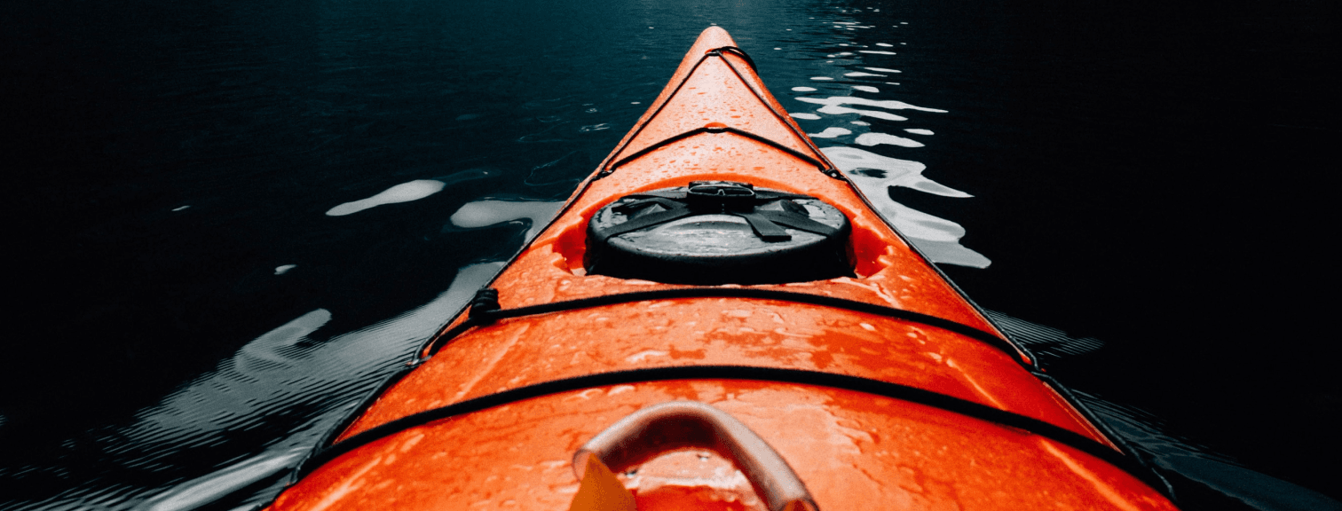 orange boat in middle of sea